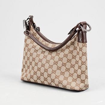 GUCCI, a beige monogram canvas shoulderhandbag.