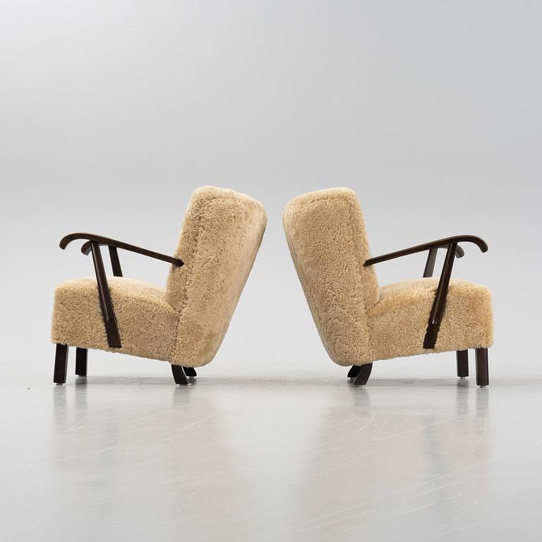 A pair of lounge chairs with new sheepskin upholstery, Denmark, 1930's/40's.