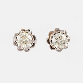 A pair of 14K gold earrings with round brilliant-cut diamonds.
