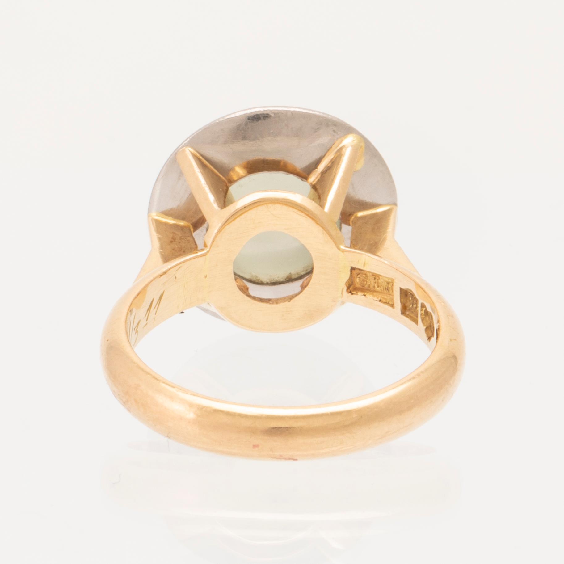 An 18K white and red gold ring set with a cabochon cut moonstone by Gustav Ljung Lund 1960.