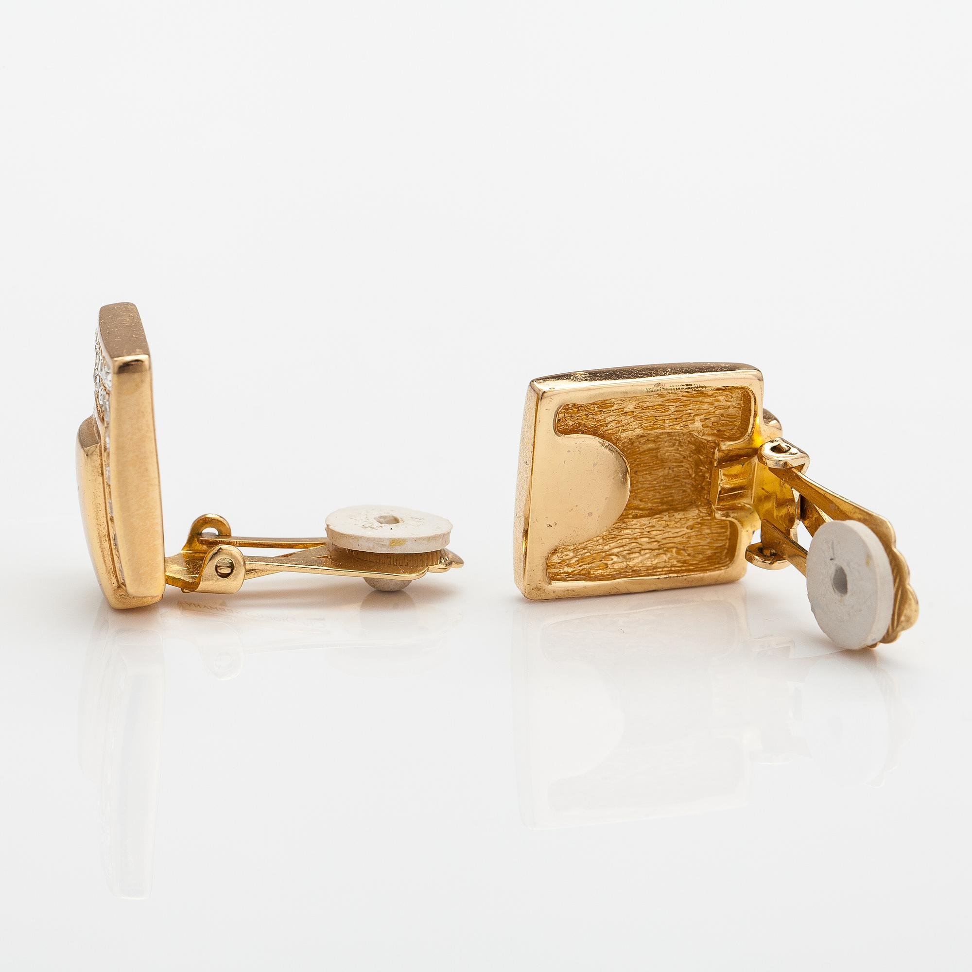 Christian Dior, A pair of gold coloured metal earrings with rhinestones. Marked Chr. Dior, Germany.