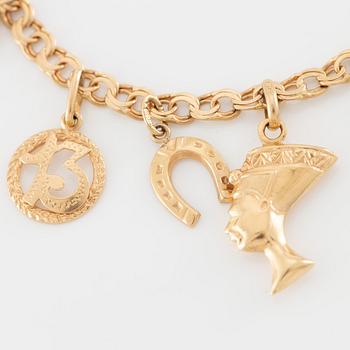 Armband 18K guld med berlocker.