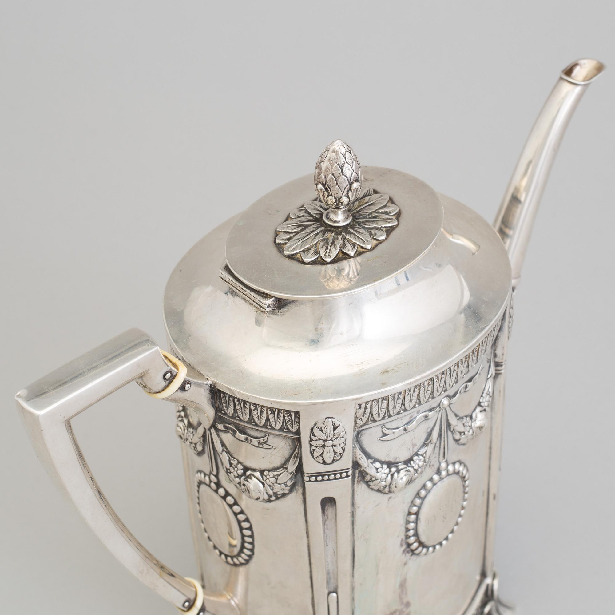 A set of three silver objects (coffeepot, creamer and sugarbowl, CG Hallberg and GAB, Stockholm 1907. Weight ca 1226 gr.