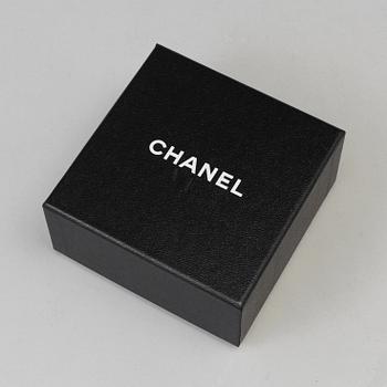 A Brooch by CHANEL.