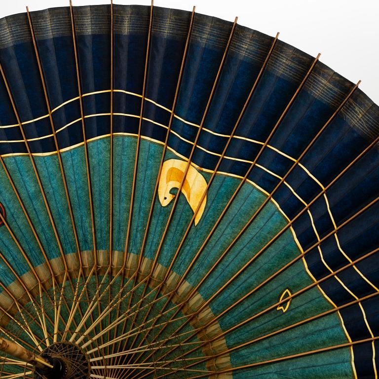 A set of six fans and two umbrellas and a wig/pony tail. Japan, early 20th Century.