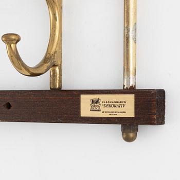 A pair of 'Dekorativ' coat hangers, Skoglunds metallgjuteri, Anderstorp, mid 20th Century.