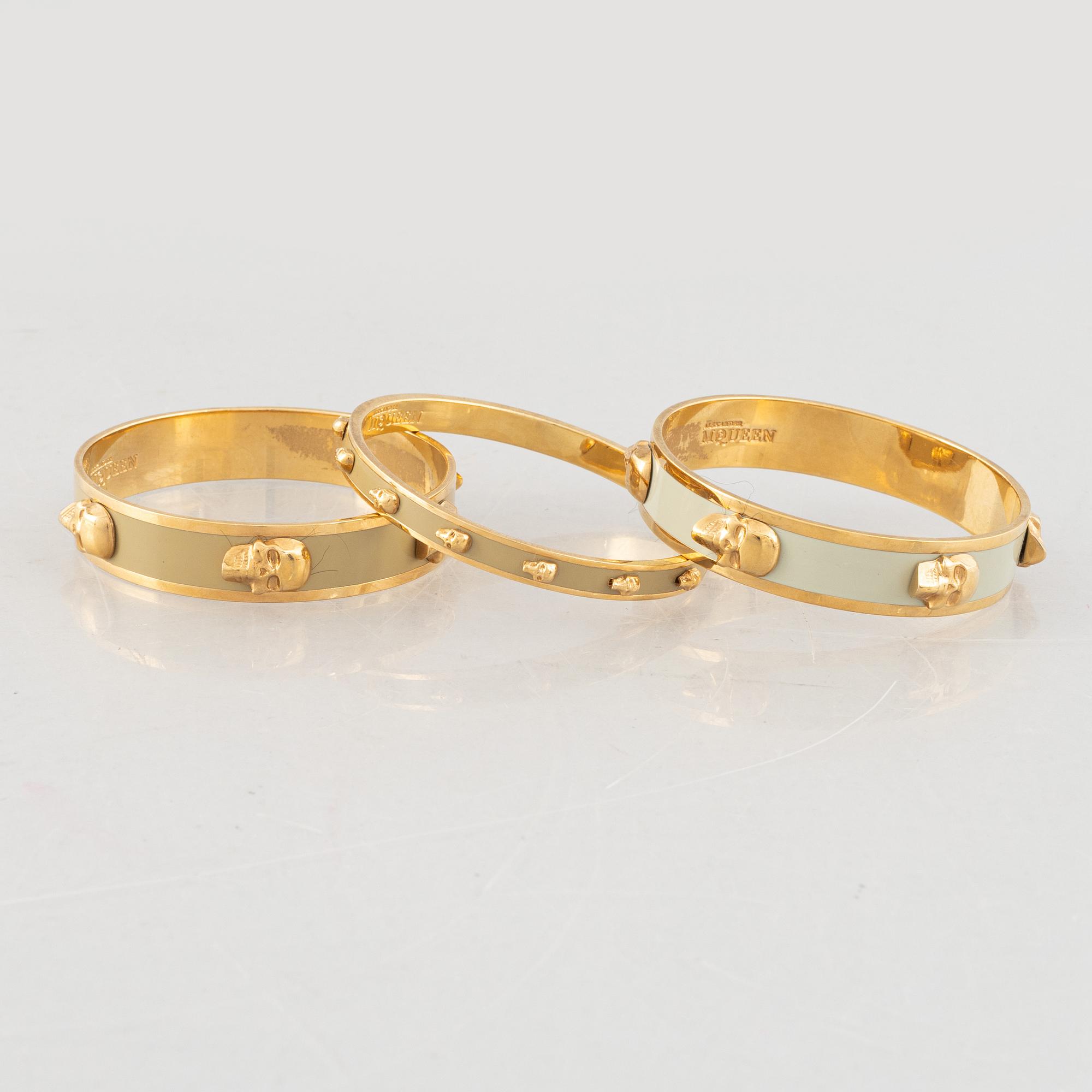 Alexander McQueen, three bracelets and a ring.