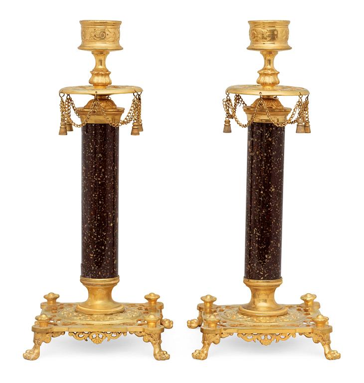 A pair of Swedish late 19th century brass and porphyry-imitation glass candlesticks.