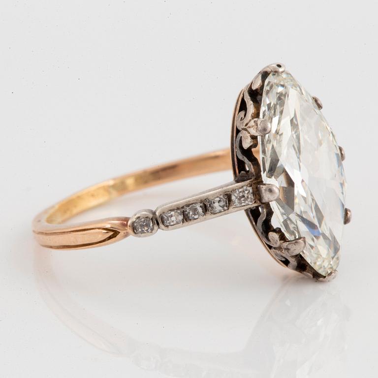 A 14K gold and silver ring set with a navette-cut diamond with a total weight of ca 2.75 cts quality ca K vs.