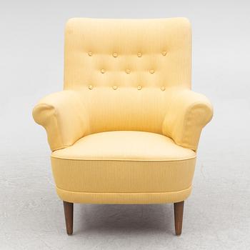 Carl Malmsten, a 'Hemmakväll' armchair and a 'Farmor' ottoman.