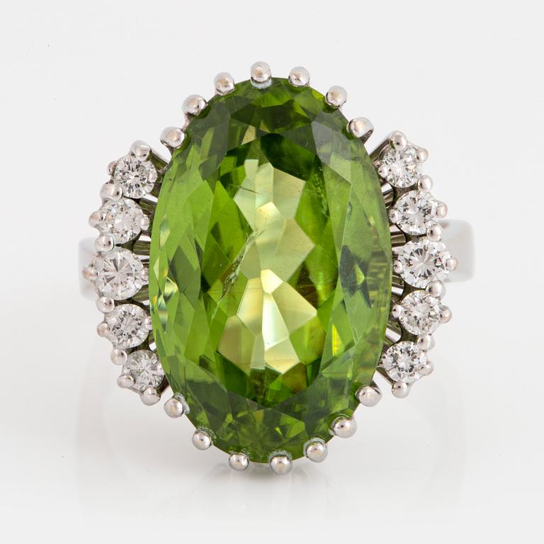 Cocktailring 18K vitguld med en fasettslipad peridot ca 11.00 ct samt runda briljantslipade diamanter.