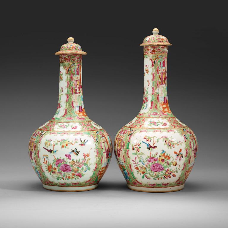 A pair of famille rose Canton vases with covers, Qing dynasty, 19th Century.