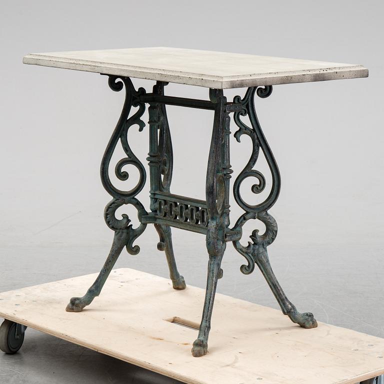 A early 20th Century cast iron garden table with later concrete top.