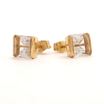 A pair of 18K gold earrings with rock crystal stones.