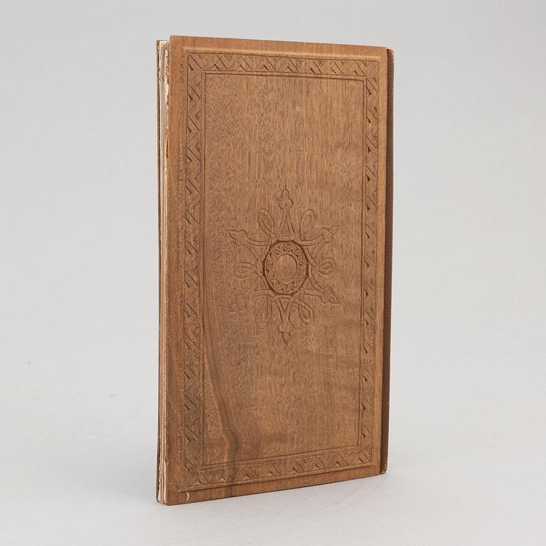 A keepsake book embellished by Ellen Jolin featuring a 'Santa Claus' figure.