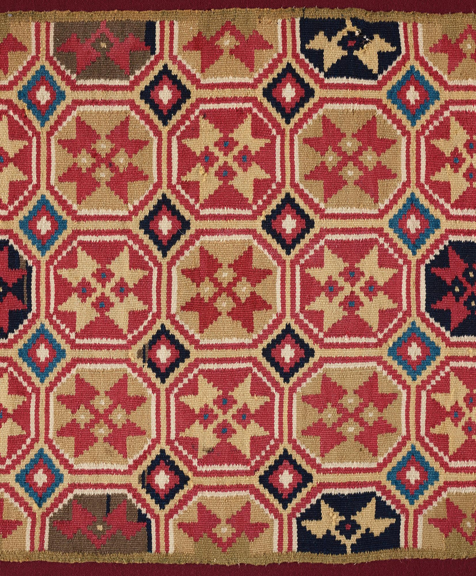 A CARRIAGE CUSHION, double-interlocked tapestry, "Stjärnmönster", ca 43,5-44,5 x 94-95 cm, Scania (Sweden).