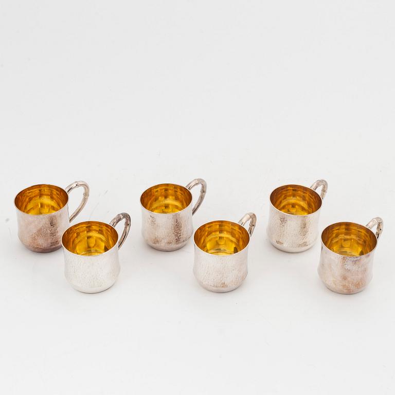 Six parcel-gilt sterling silver jugs.