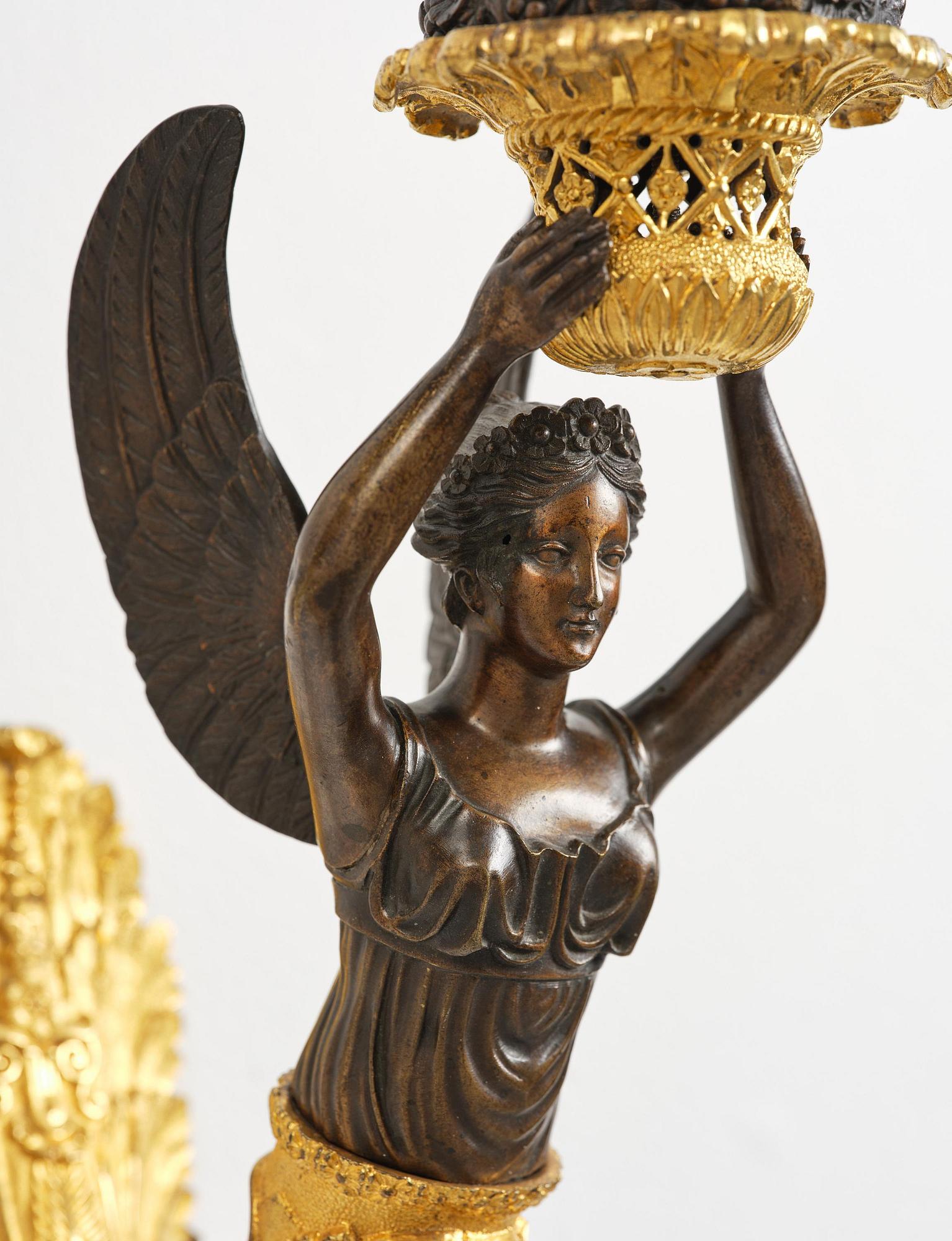 A pair of French Empire five-branch gilt and patinated bronze appliques, first part 19th century.