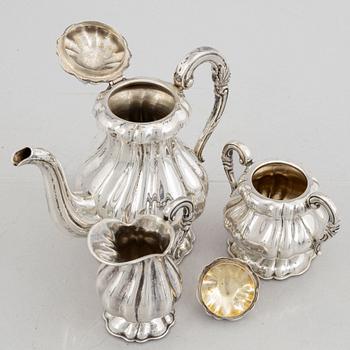 A silver coffee pot, a creamer and a sugarbowl, 20th Century.