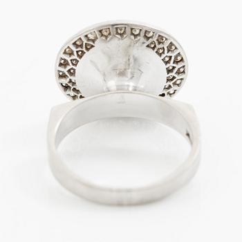 A ring 18K white gold set with an opal and eight-cut diamonds. CF Carlman, Stockholm 1973.