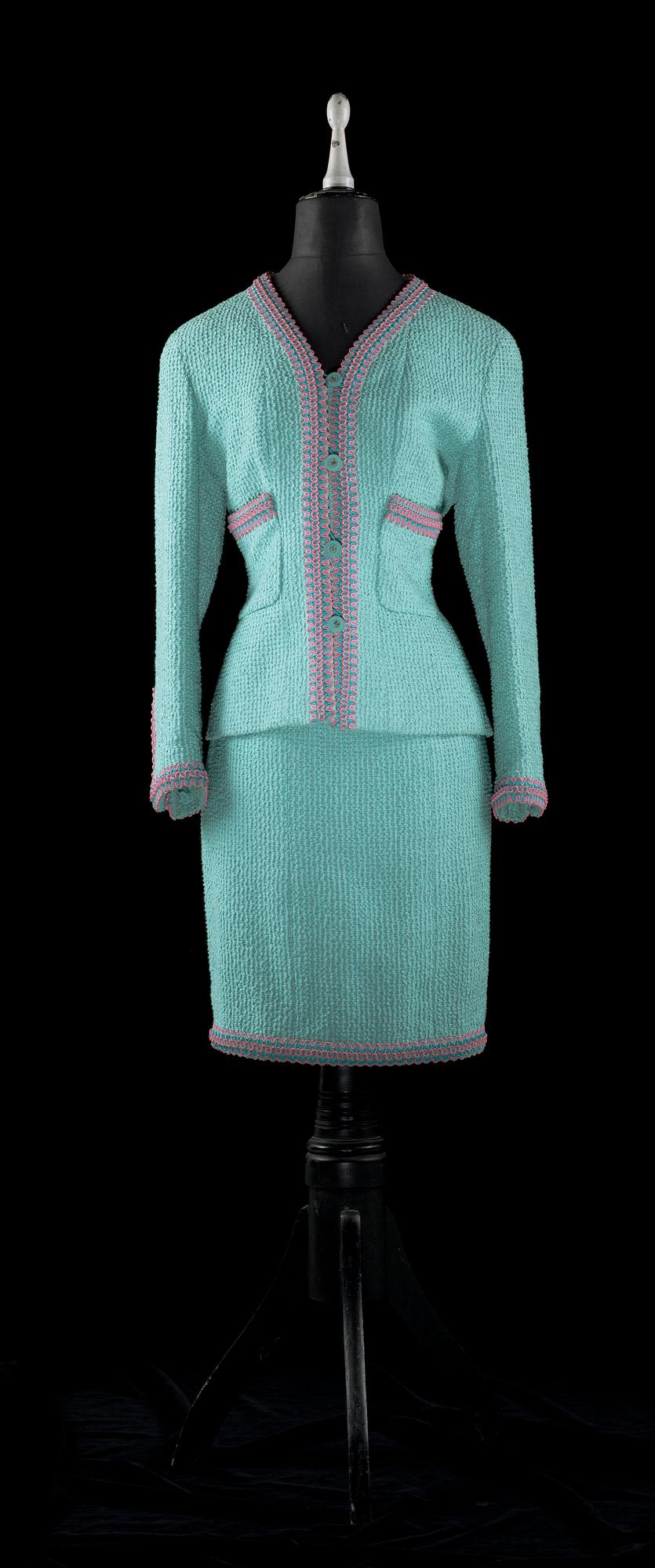 A 21 th cent green bouclé two-pieces costume by Chanel.