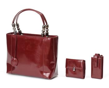 564. A handbag/shoulder bag, wallet and cellphone case by Christian Dior.