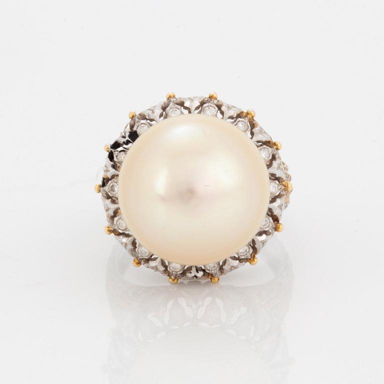 An 18K gold ring set with a cultured pearl and round brilliant-cut diamonds.