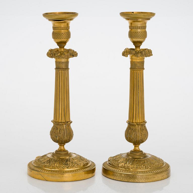 A pair of Empire ormolu brass candlesticks, France early 19th century.