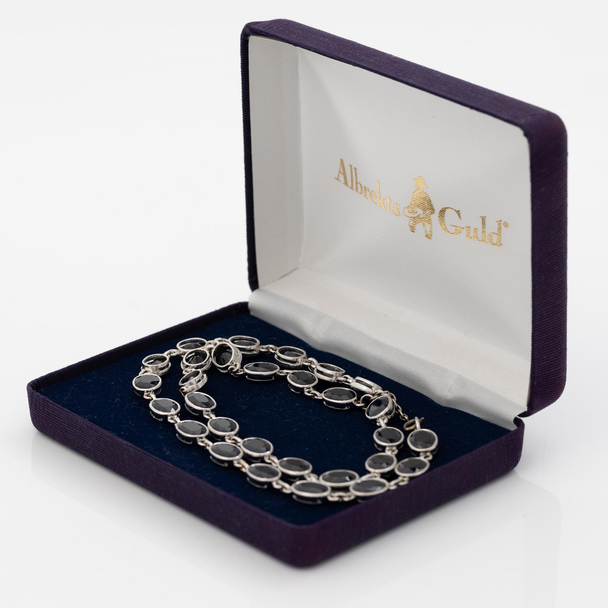 18K white gold necklace with dark sapphires.