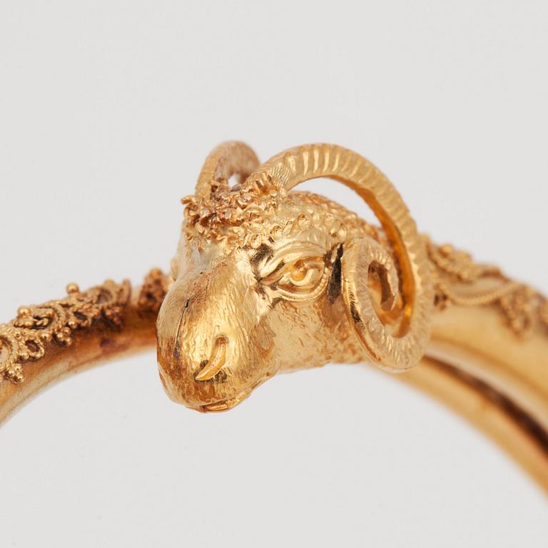 An etruscan revival rams head gold bangle.