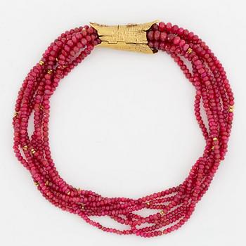 A W Nussberger ruby necklace with an 18K gold clasp set with princess-cut diamonds.