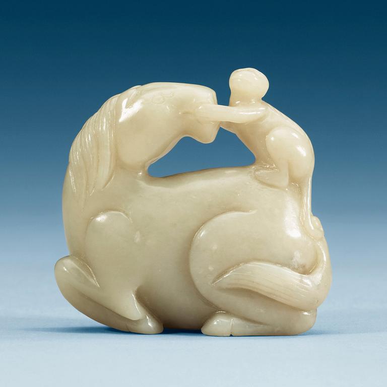 A nephrite figure of a reclining horse with a monkey, China.