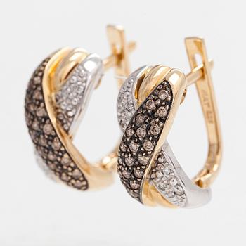 A pair of 14K white/yellow gold earrings, with clear and brown diamonds totaling approximately 0.40 ct.