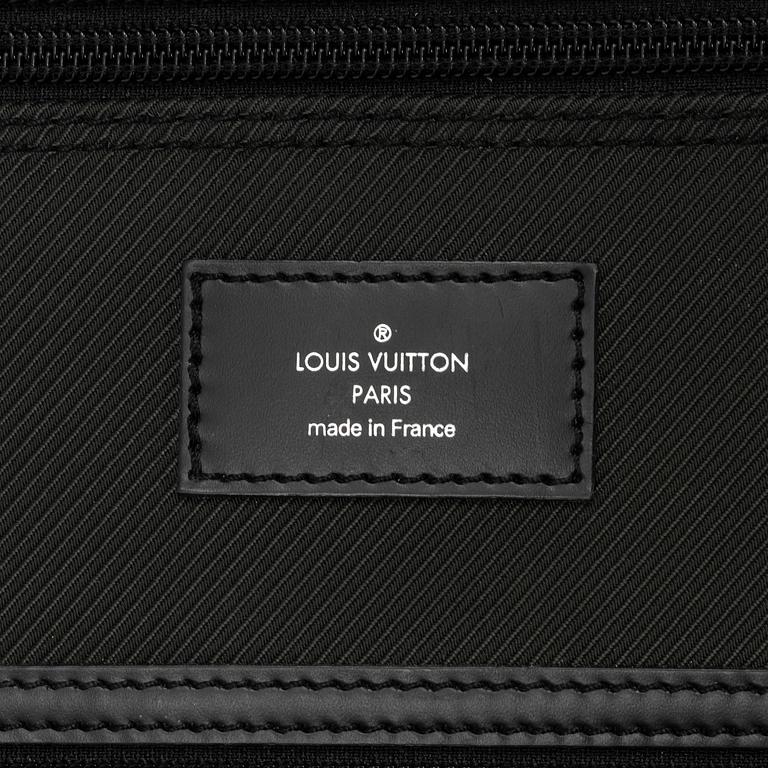Louis Vuitton, a green canvas and Taiga garment bag.