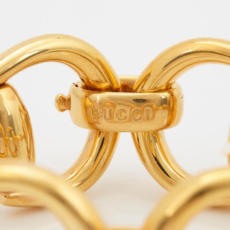 An 18K gold Gucci bracelet.