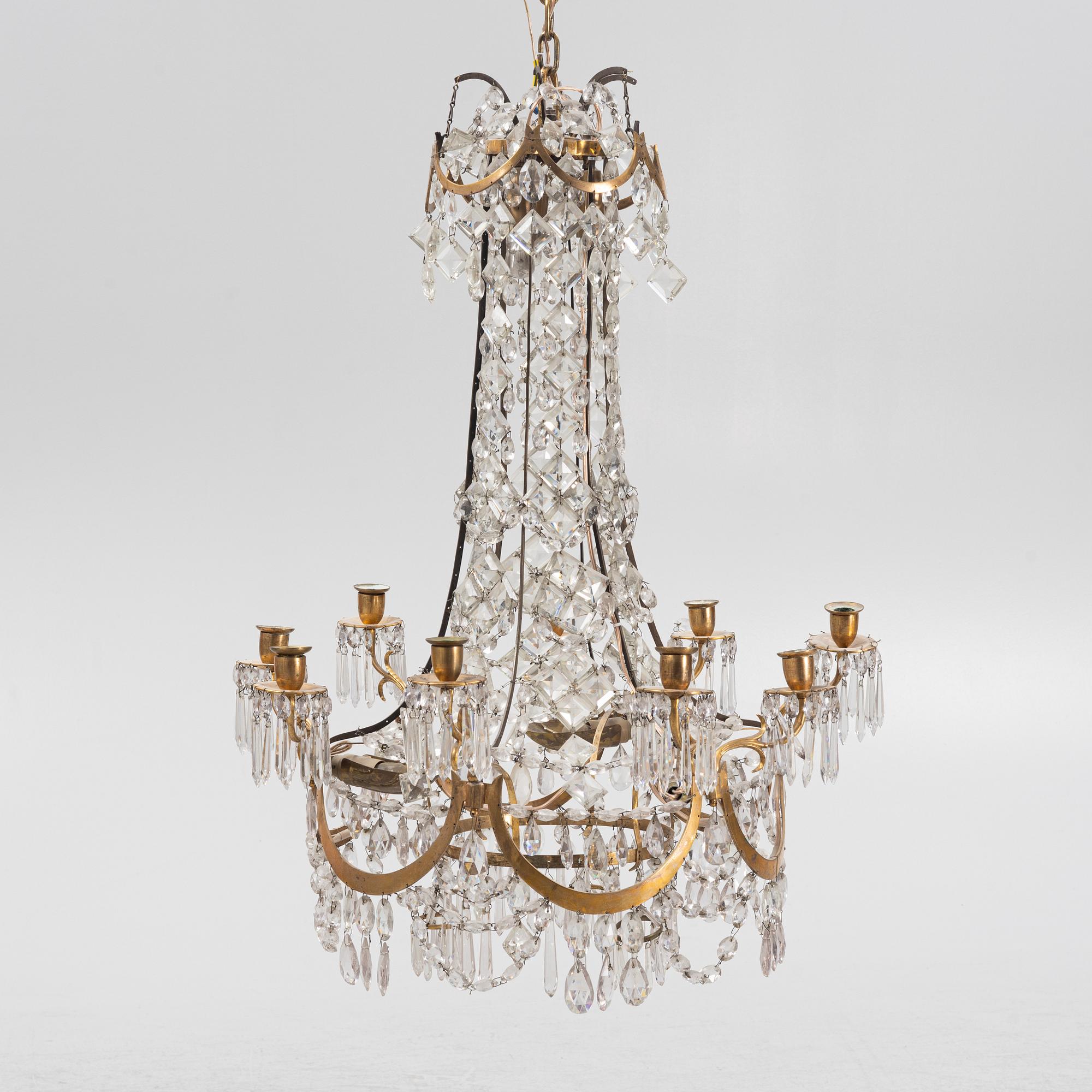 A Louis XVI gilt-brass and cut glass nine-light chandelier, circa 1800.