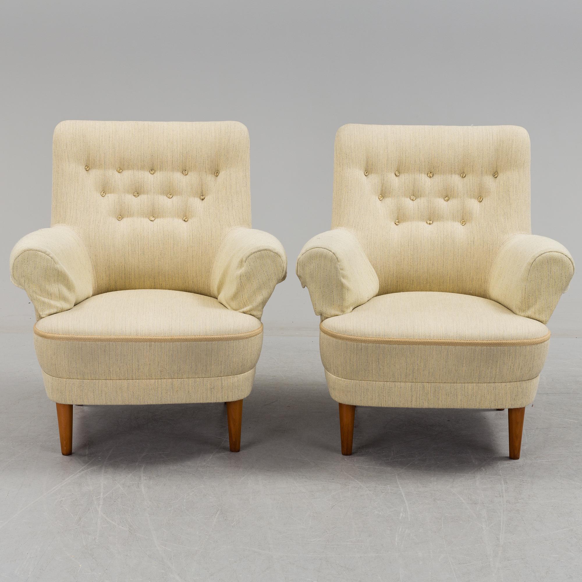 A pair of second half of the 20th century 'Hemmakväll' easy chairs by Carl Malmsten.