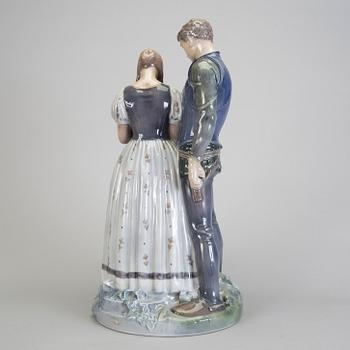 A porcelain figurine of a boy and girl model 3171 Royal Copenhagen.