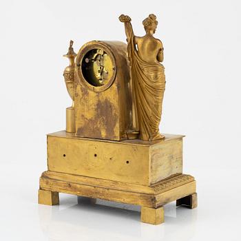 An ormolu Empire mantel clock, first part of the 19th century.