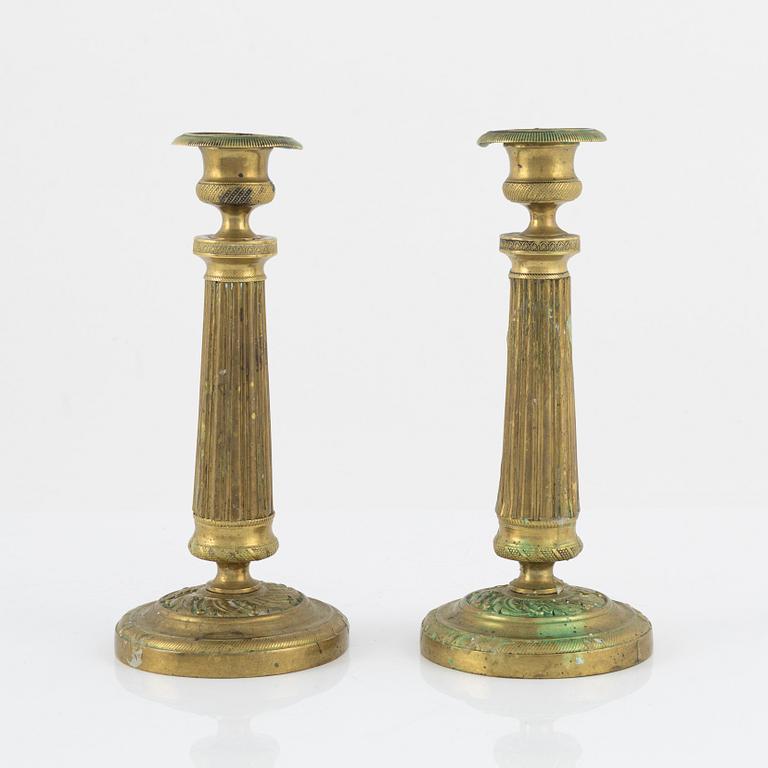 A pair of Empire bronze candlesticks, first half of the 19th Century.