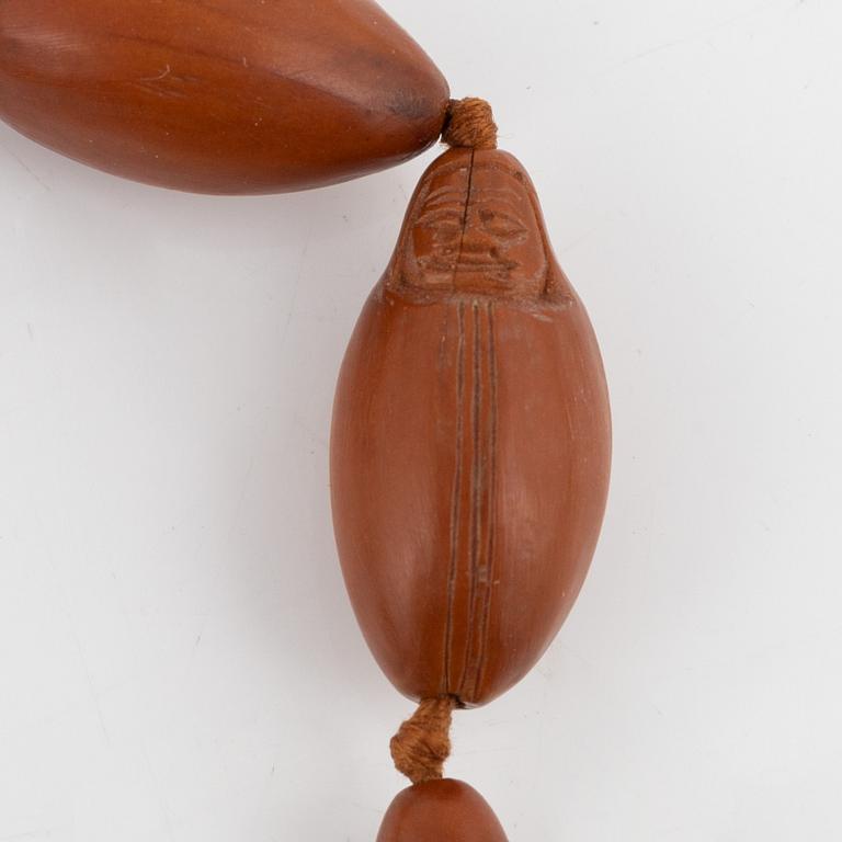 A necklace with sculptured nuts, circa 1900.