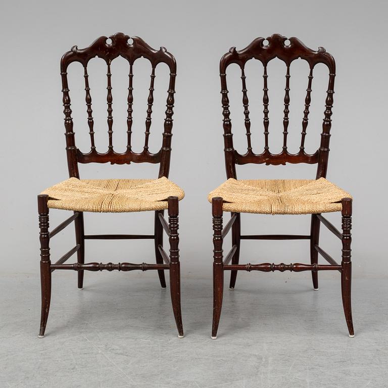 A pair of Chiavari chairs.