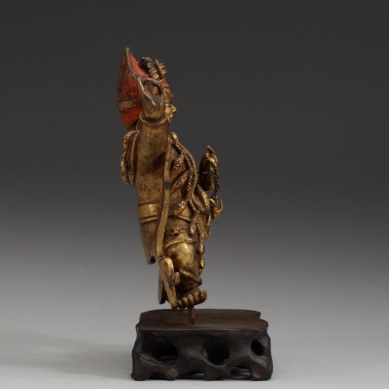 A Sinotibetan gilt bronze  figure of a Dharmapala.
