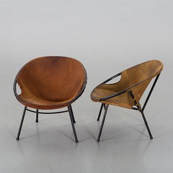 A pair of 1960s-70s steel and leather easy chairs.