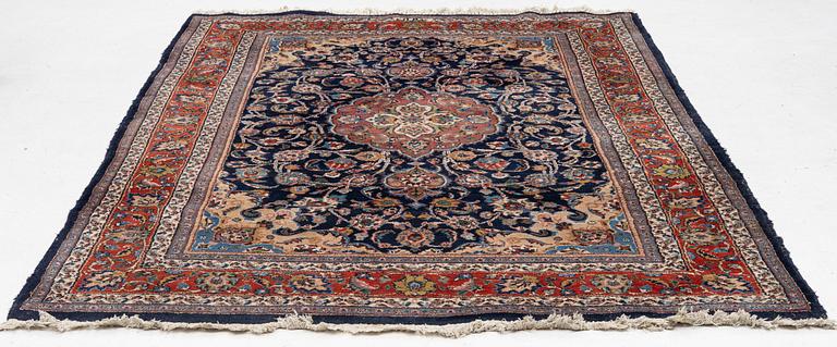 A Mashad carpet, signed, c. 289 x 198 cm.