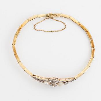 A 14K gold and platinum bracelet set with old- and rose-cut diamonds and pearls.
