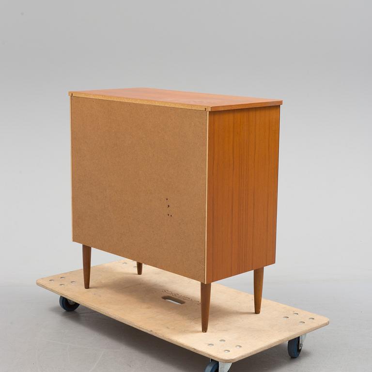 A second half of the 20th century teak veneered chest of four drawers.