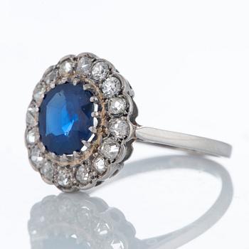 A platinum ring set with a faceted sapphire ca 1.90 cts and old-cut diamonds with a total weight of ca 0.50 cts.