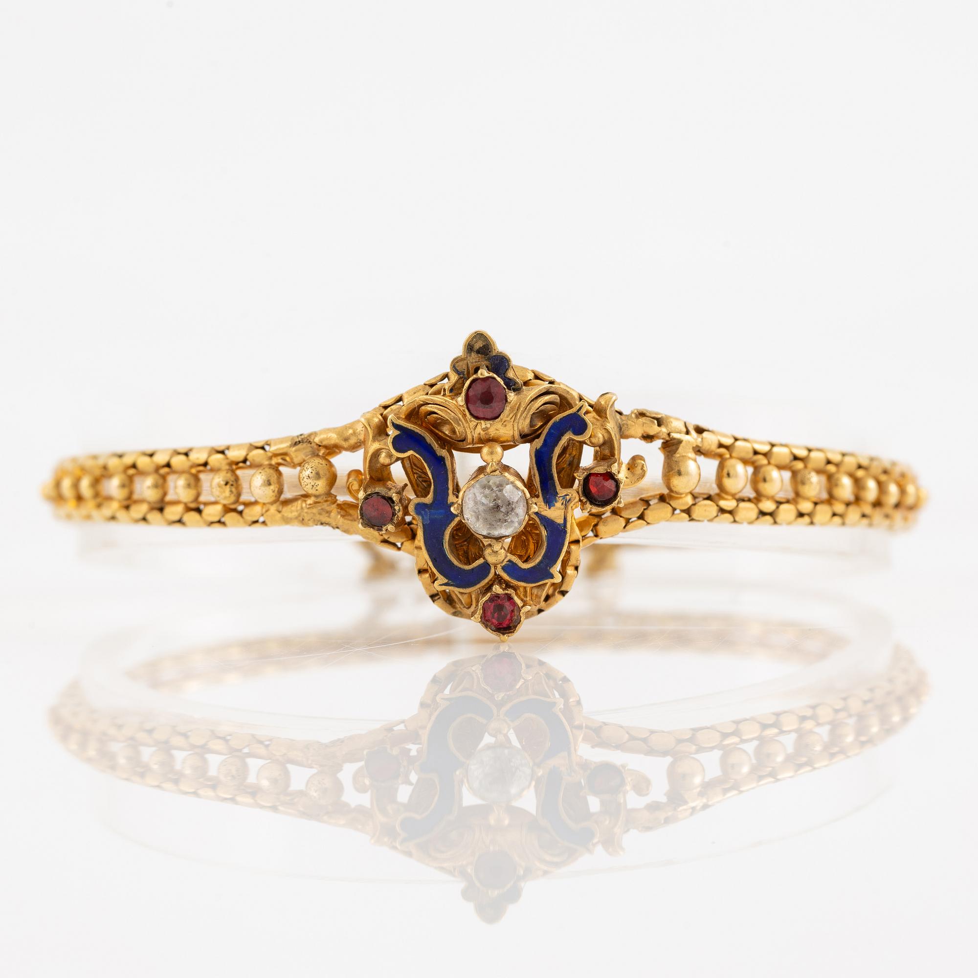 Bracelet, gilded metal with paste stones and enamel.