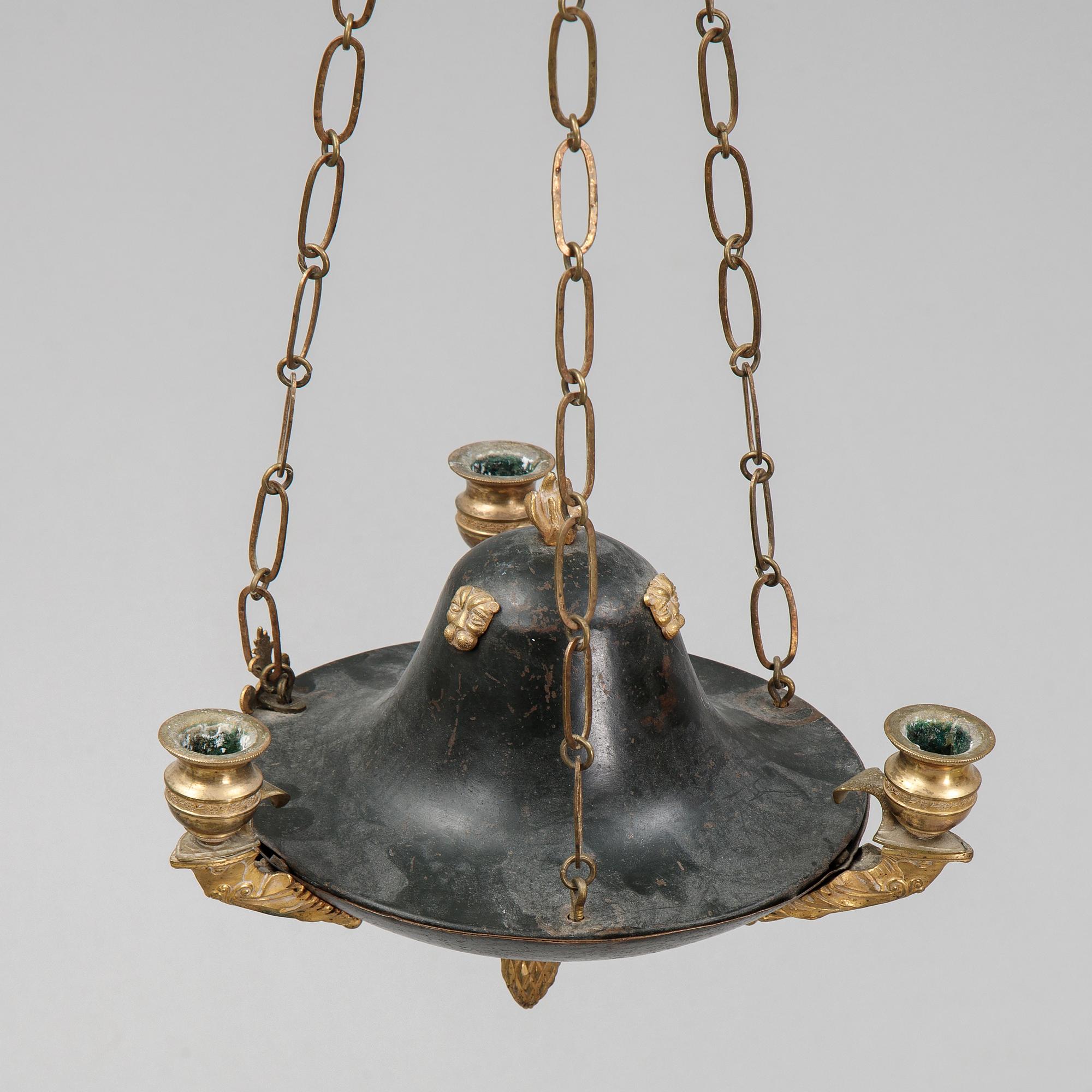 A Swedish Empire style 20th century three-light patinated brass hanging-lamp.